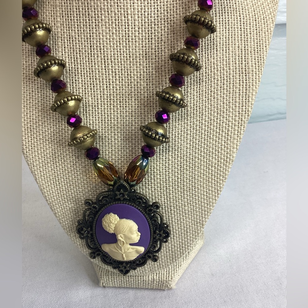 Purple beaded cameo necklace.